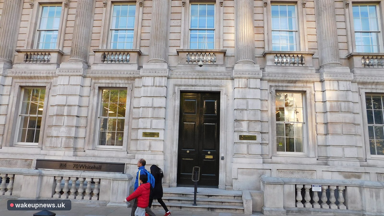 Stone facade and black front door of the Cabinet Office at 70 Whitehall, London