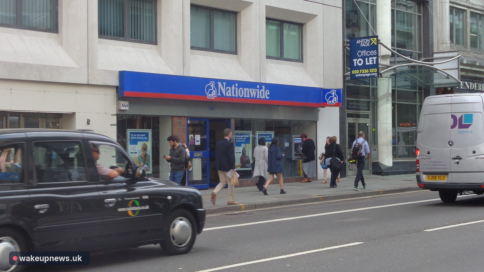 Nationwide Building Society branch in London with a black taxi passing and pedestrians