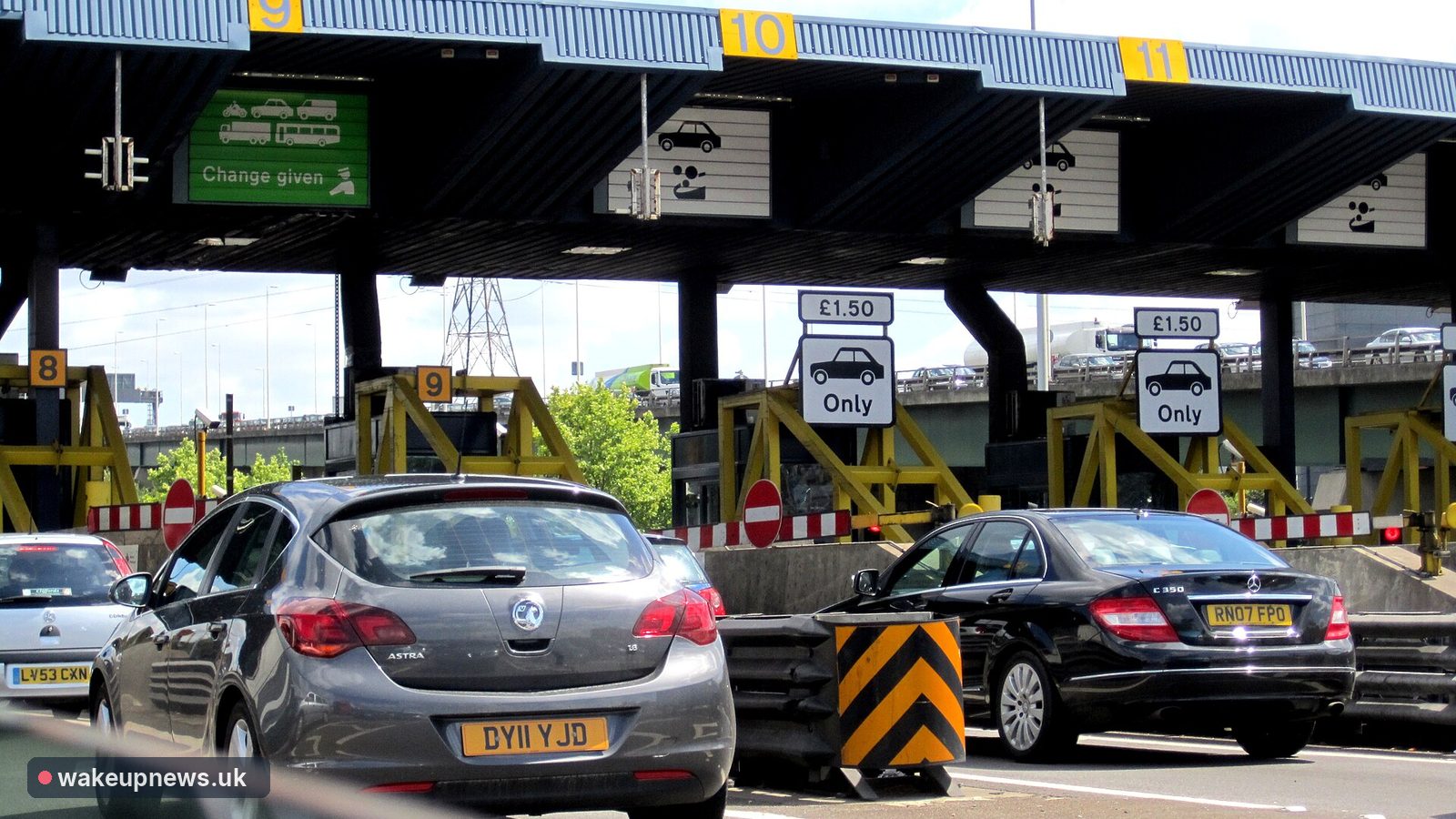 Cars queue at toll booths at the Dartford Crossing, with £1.50 car toll signs overhead